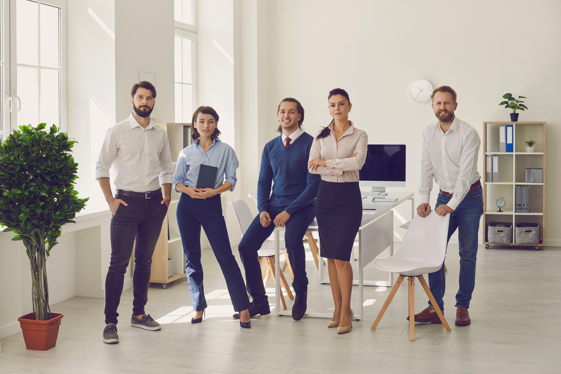 Group of Young Professionals Standing in Modern Office Ready for Corporate Meeting
